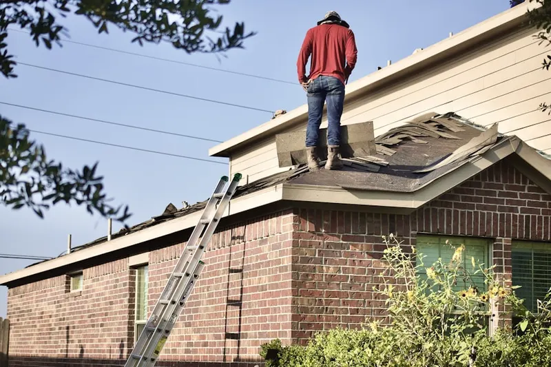 Professional roofer working on a residential roof in Franklin Farm
